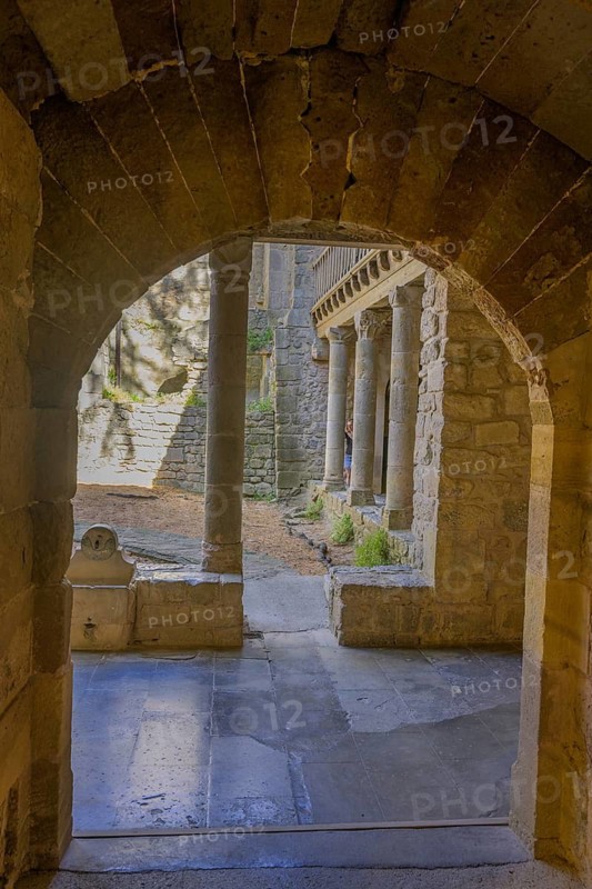 View through the portal onto the inner courtyard of Saint Marie Abbey in Lagrasse, Département Aude, France