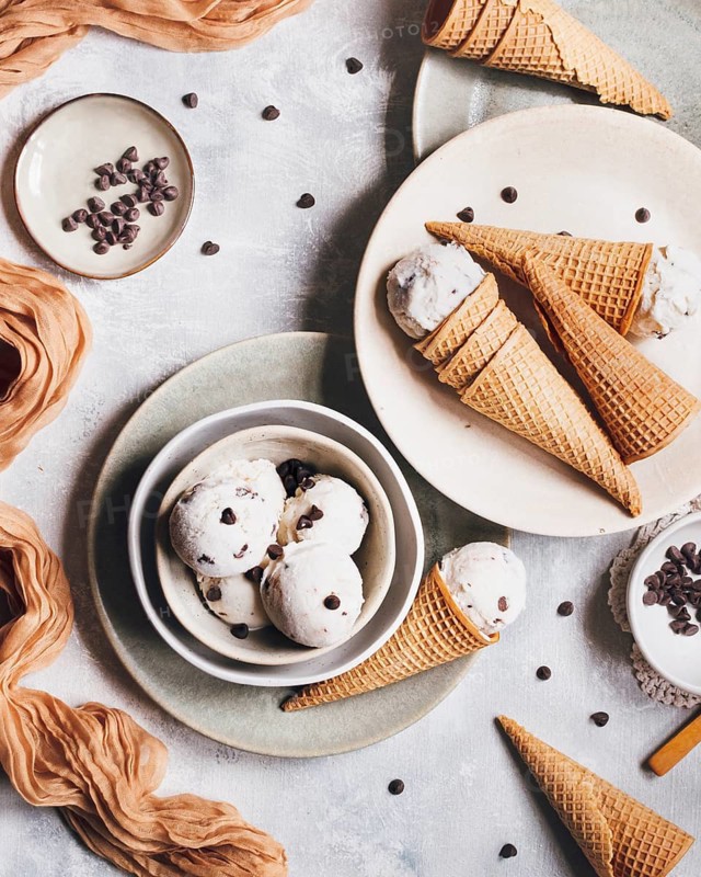 Delicious banana ice cream with Greek yogurt and chocolate chips, beautifully served in crispy cones. A delightful treat capturing the essence of sweet indulgence