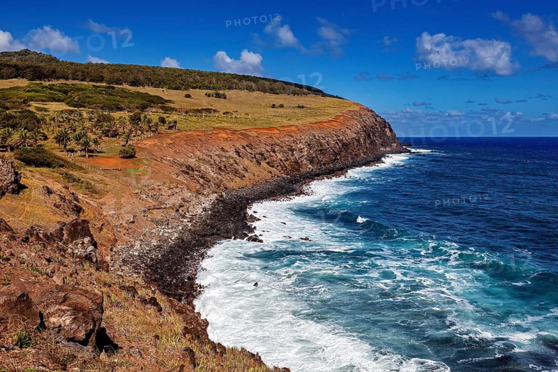 Coastal landscape with rocks and turquoise sea under clear sky, The landscape of Easter Island in the Pacific Ocean