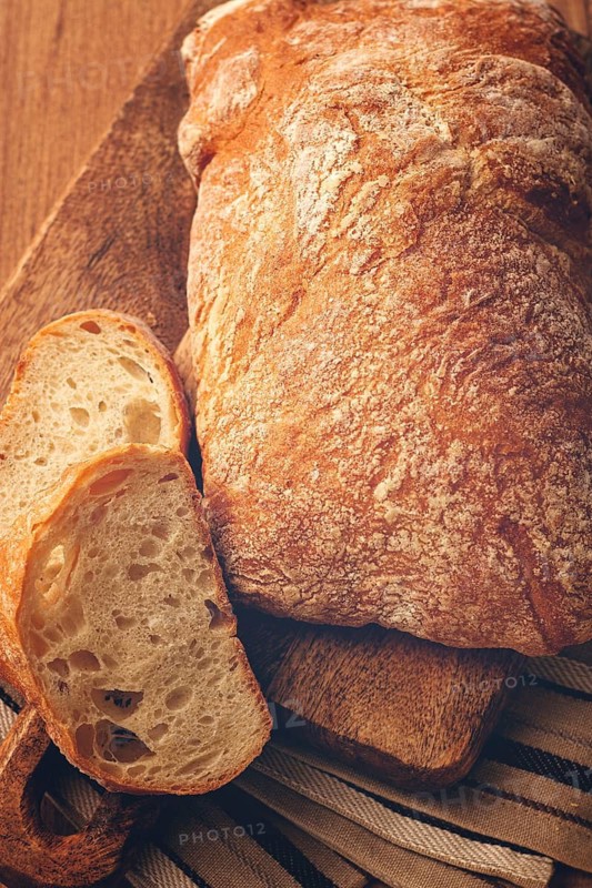Sliced ciabatta, on a chopping board, italian bread, close-up, Italian cuisine, breakfast, no people