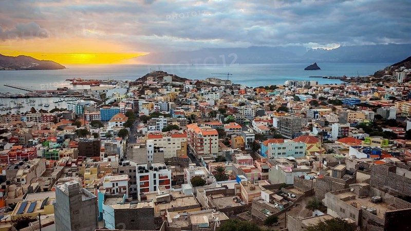 Panoramic view from above of coastal town of Mindelo at sunset with colorful buildings, harbor and mountains, Mindelo, Sao Vicente, Cabo Verde, Cape Verde, Cape Verde