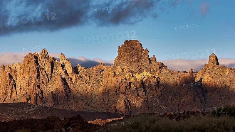 Llano de Ucanca, rocky mountain at sunset with clouds and deep shade, Teide, Parque Nacional del Teide, Teide National Park, volcano, volcanism, UNESCO World Heritage Site, Tenerife, Canary Islands, Spain