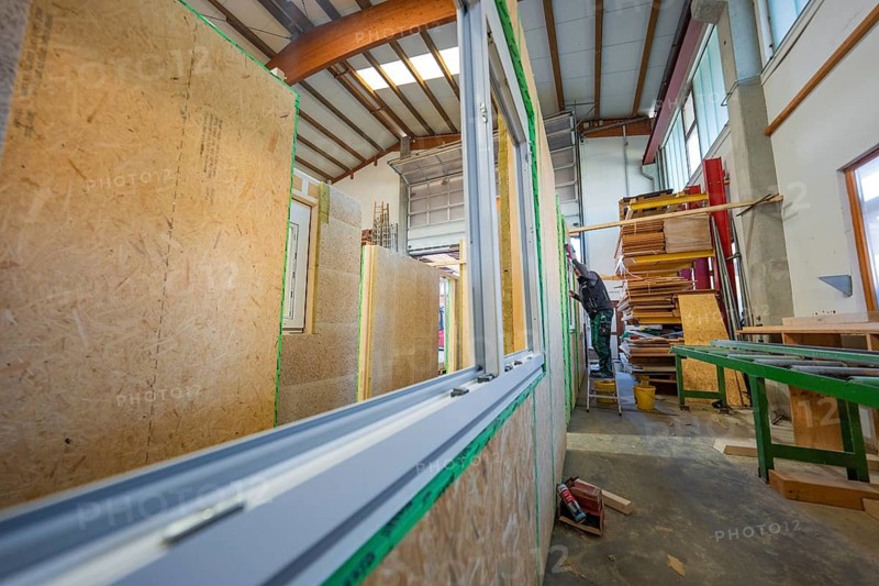 Construction of wooden walls in a workshop, window assembled, structured work environment, façade construction in carpentry, climate-friendly construction, Nagold, Germany
