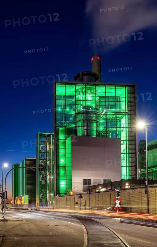 The Lausward combined heat and power plant in Düsseldorf, gas and steam turbine power plant, operated by Stadtwerke Düsseldorf and EnBW, in the harbour of Düsseldorf on the Rhine, green illuminated city window, the chimney of the Fortuna power plant unit, the power plant generates electricity, also traction current and district heating, North Rhine-Westphalia, Germany