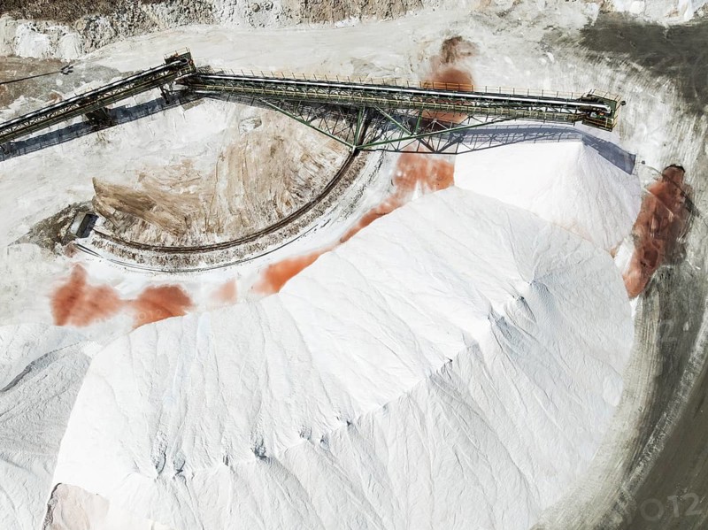 Conveyor belt and salt heaps at the Walvis Bay Salt works. Aerial view. Drone shot. Walvis Bay, Namibia