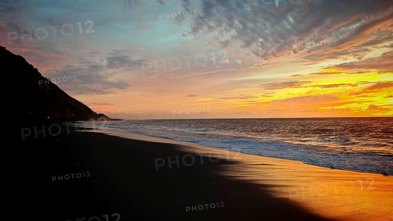 Glowing sunset on dark beach against mountains and glowing sky, volcanic sand, hiking, Tarrafal de Monte Trigo, Santo Antao, Cabo Verde, Cape Verde, Cape Verde