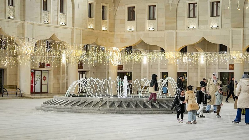 Muslim families and individuals gather at outdoor tables for a mass community Iftar meal under festive Ramadan lights in Gaziantep, Turkey on March 11, 2026, Gaziantep, Turkey