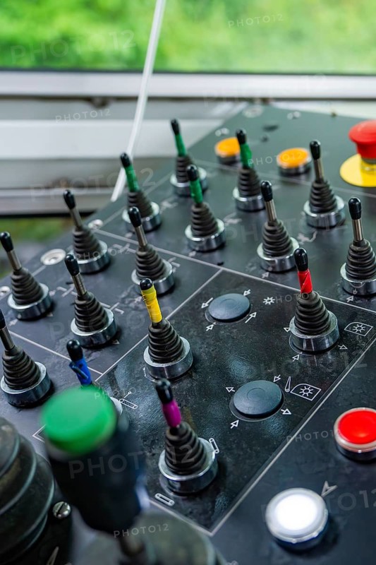Control panel with levers and coloured buttons in front of a window front, Hermann Hesse Bahn track construction, Calw district, Black Forest, Germany