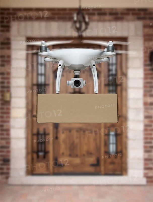 Unmanned Aircraft System (UAV) Quadcopter Drone Delivering Package To House