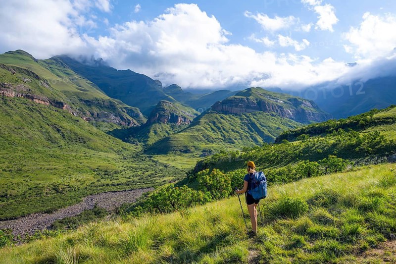 Young female hiker between mountains, Drakensberg National Park, KwaZulu Natal, South Africa