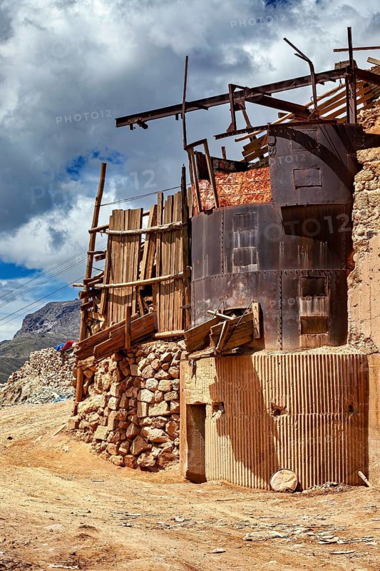 Dilapidated building made of wood and metal against a cloudy sky in a mountain landscape, The silver mines near Potosi on Cerro Rico in Bolivia