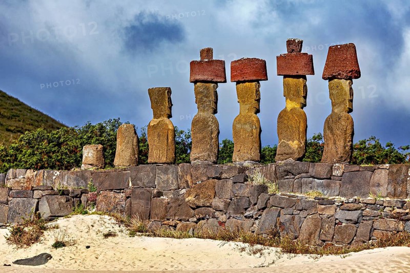 Close-up of Moai statues on Easter Island under a dramatically cloudy sky, The Moai statues on Easter Island in the Pacific Ocean