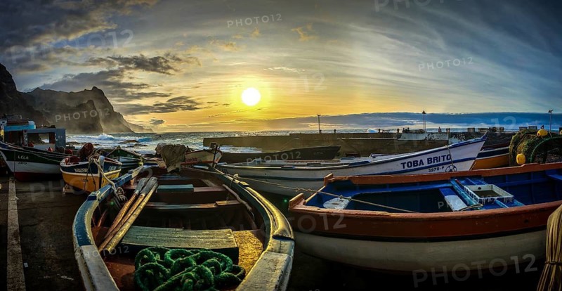 Colourful fishing boats rest on the shore in the soft light of an evening sunset, romantic harbor scene, Ponta do Sol, Santo Antao, Cabo Verde, Cape Verde, Cape Verde