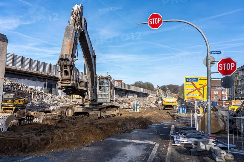 Demolition of the 120 meter long motorway bridge of the A516, across Teutoburger Straße in Oberhausen-Sterkrade, the bridge, built in 1970 was severely damaged, traffic continues to roll on the still existing West Bridge, after the demolition, the eastern part is rebuilt using a process unique in the world, 40 meter long precast concrete beams are assembled one after the other, reducing the construction period from 24 to 7 months after the completion of this bridge Will the western part also be rebuilt, North Rhine-Westphalia, Germany