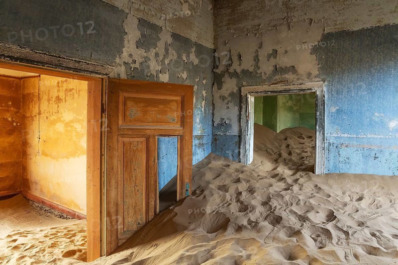 At Kolmanskop, the abandoned ghost town of the diamond days of the early 1900 and of German origin. Inside the restricted Diamond Area east of the coastal town of Lüderitz. Namib Desert, Namibia