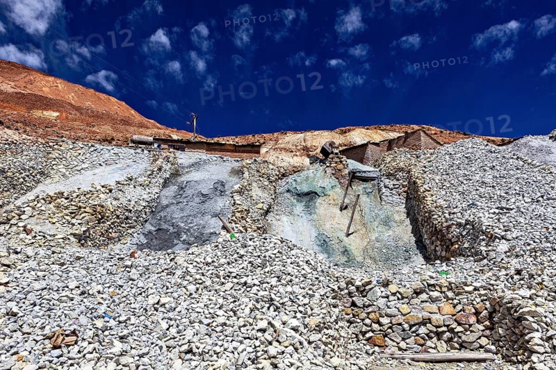 Rubble hills under a deep blue sky with some clouds, The silver mines of Potosi on Cerro Rico in Bolivia