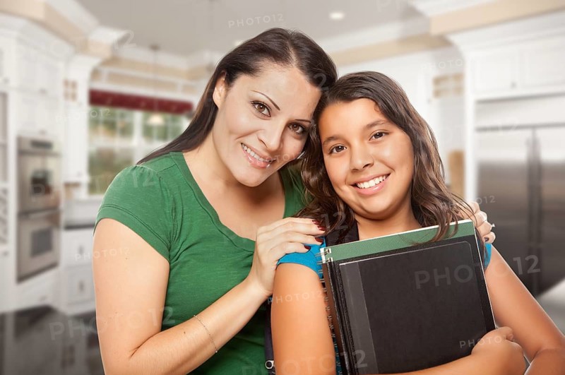 Proud Hispanic Mother and Daughter In Kitchen at Home Ready for School
