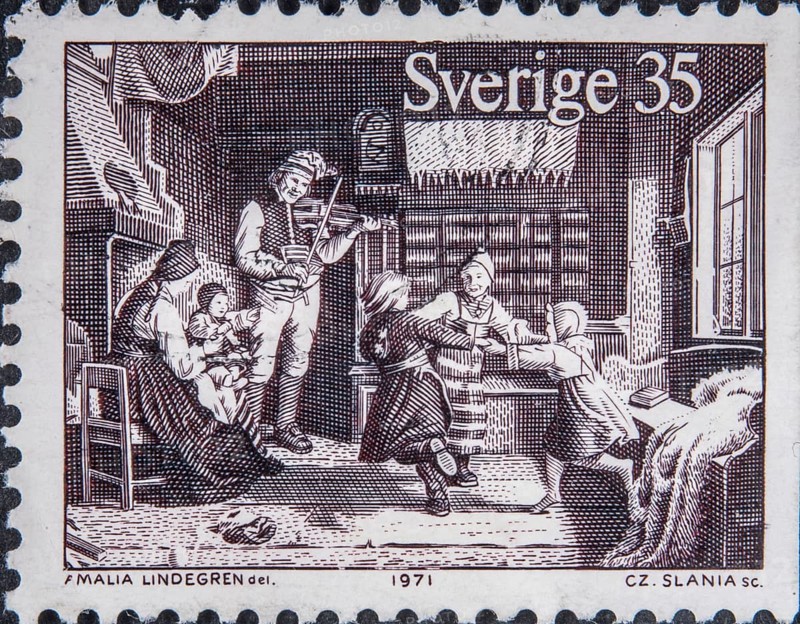Family Christmas celebration with music and games in 19th century Sweden. Picture on Swedish stamp