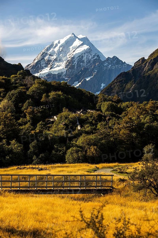 Stunning beauty of Mount Cook in New Zealand during autumn. Golden foliage and clear skies create a breathtaking landscape at this iconic location