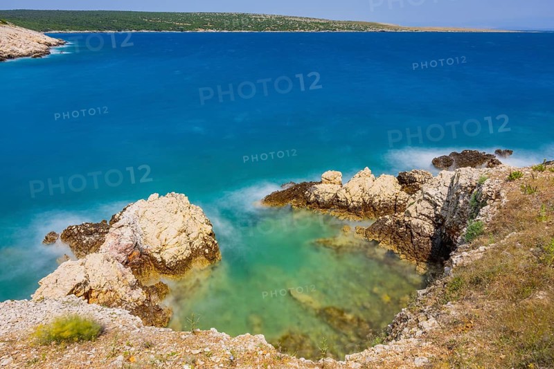 Romantic view over the sea in Koromacna Bay on a sunny day with rough seas on the island of Cres, long exposure, Croatia