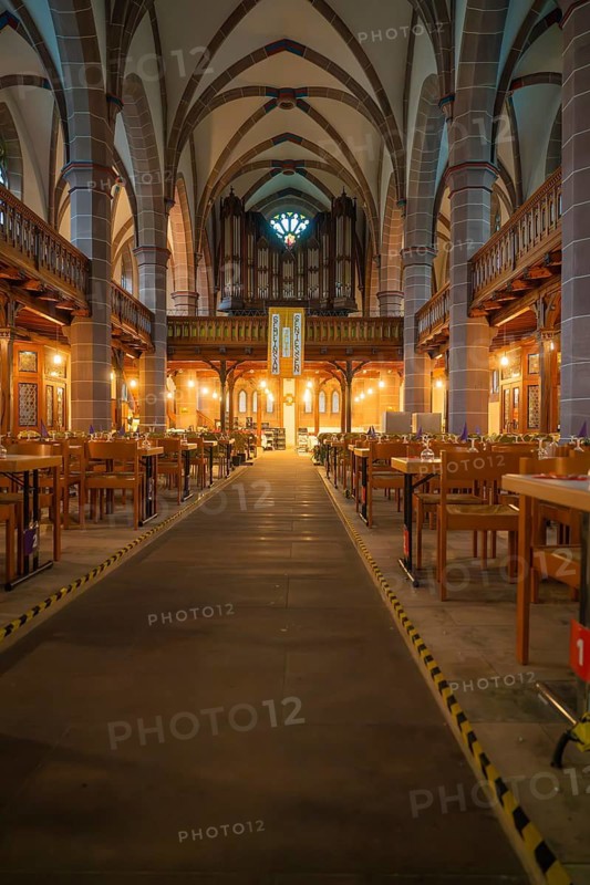 Central passageway in a church with covered tables on both sides, Vesperkirche Calw, Black Forest, Germany