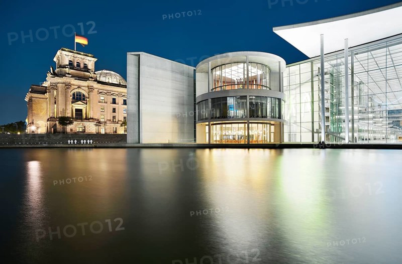 The Reichstag with the German flag and the Paul Löbe House of the German Bundestag on the Spree at dusk, blue hour, government district, Berlin-Mitte, Berlin, Germany