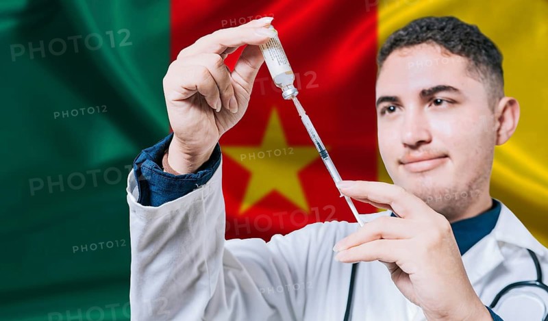 Doctor holding syringe on Cameroon flag background. Medical professional holding syringe with Cameroonian flag in the background