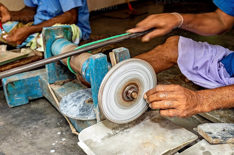Close-up of a hand working a whetstone with a machine, The gemstone cutters in the city of Ratnapura in Sri Lanka