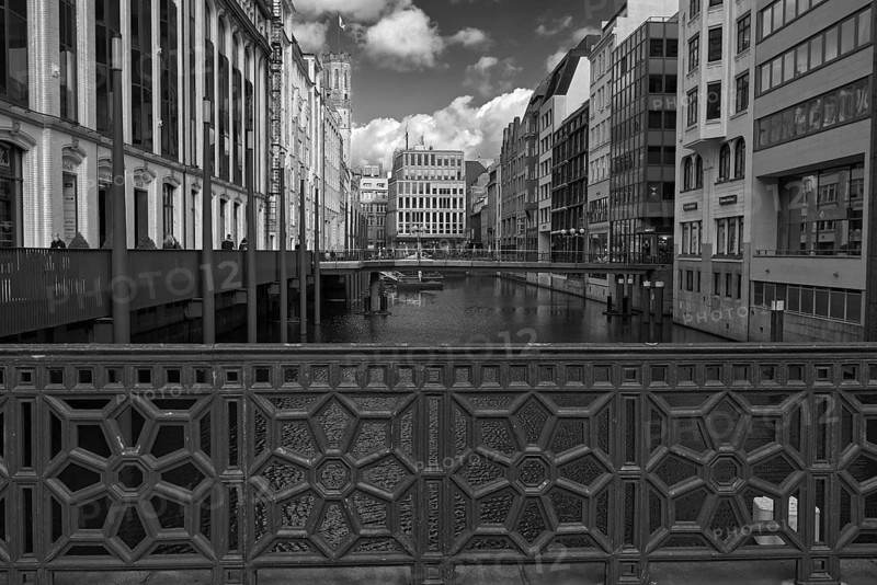 Black and white photograph of a bridge across a canal with surrounding historic buildings, Hamburg, Germany