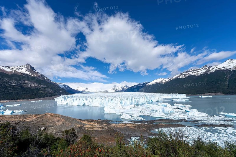Perito Moreno glacier with breakout edge in Lake Argentino, surrounded by snow-capped Andes, chunks of ice floating on the water, Los Glaciares National Park, Santa Cruz Province, Patagonia, Argentina