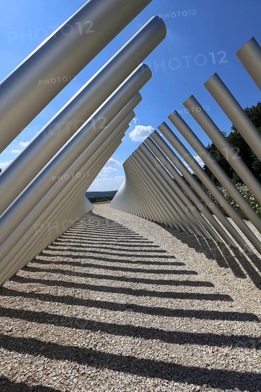 Art in public space, sculpture made of aluminum profile pipes by artist Martin Burchard, life's horizon path near Mundingen, light and shadow, gravel, clouds, blue sky, walk-in art, paths of reflection and refreshment on the Ehinger Alb, Baden-Württemberg, Germany
