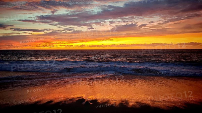 Romantic sunset over gentle waves on the beach, the sky glows in warm colors, Tarrafal de Monte Trigo, Santo Antao, Cabo Verde, Cape Verde, Cape Verde