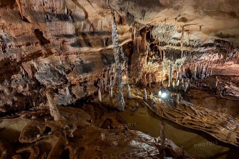 Stalactites and stalagmites, rock formations in a stalactite cave with water basin, Grotta del Fico, Gulf of Orosei, Baunei, Sardinia, Italy