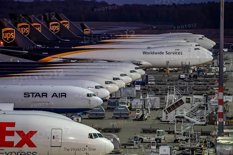 Cologne-Bonn airport, CGN, air freight center, UPS Logisic Hub, UPS cargo aircraft on the apron, FedEx and Star Air Cargo aircraft, Maersk, at the logistics center, in the evening