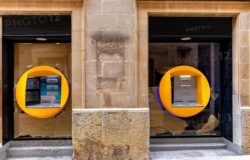 Caixa banking house with ATMs in the small town of Pollenca, Majorca, Balearic Islands, Spain