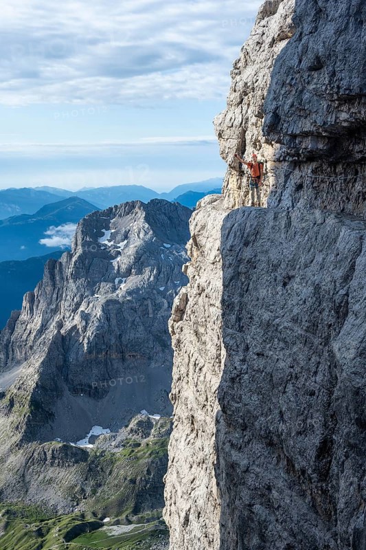 Climbers on a rock band, Bocchette Centrale band trail, via ferrata in the Brenta Mountains, Brenta-Adamello Natural Park, Trentino, Italy