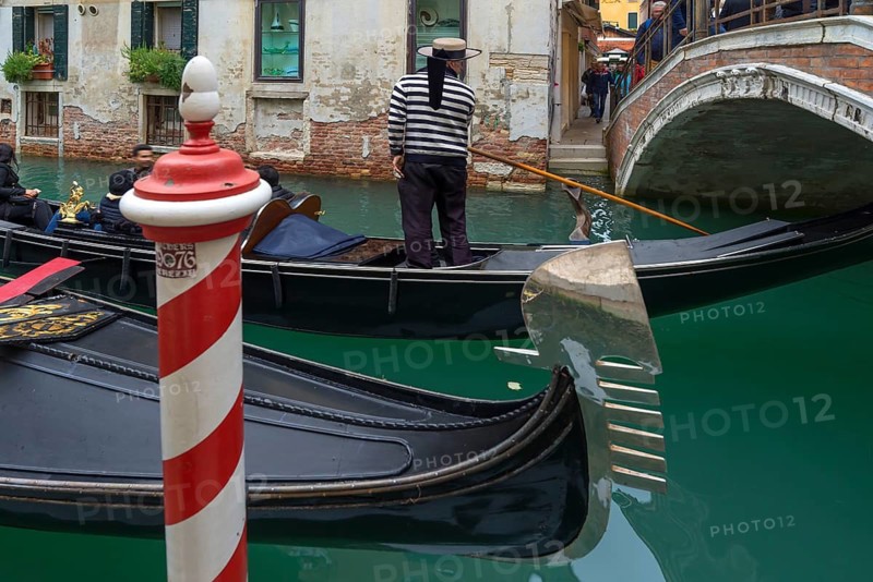 Gondola ride with tourists through the old town of Venice, Veneto, Italy