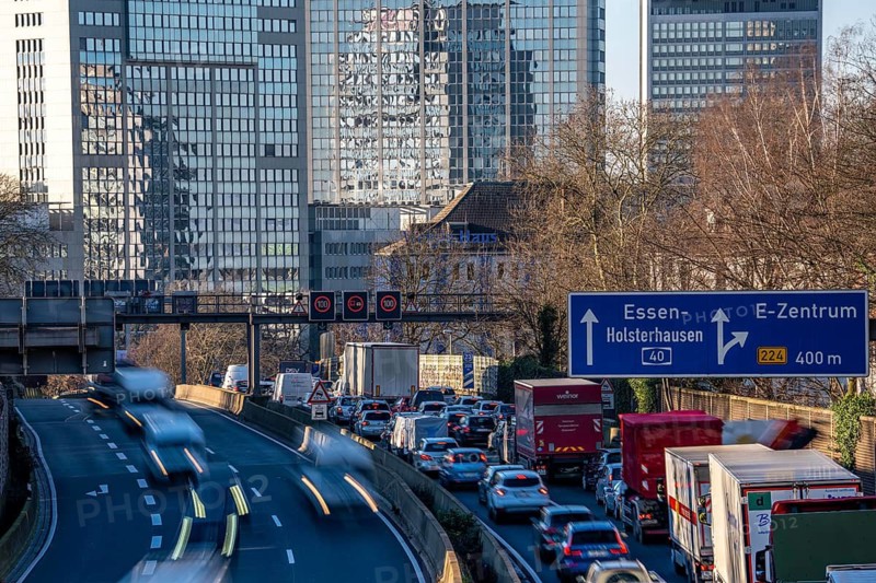 The A40 motorway, Ruhrschnellweg, in Essen, city skyline, Evonik office building, traffic jam in the westbound lane, Duisburg, slow traffic, North Rhine-Westphalia, Germany