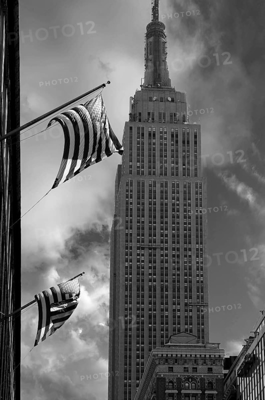 Waving US flag with Empire State Building, New York City, USA