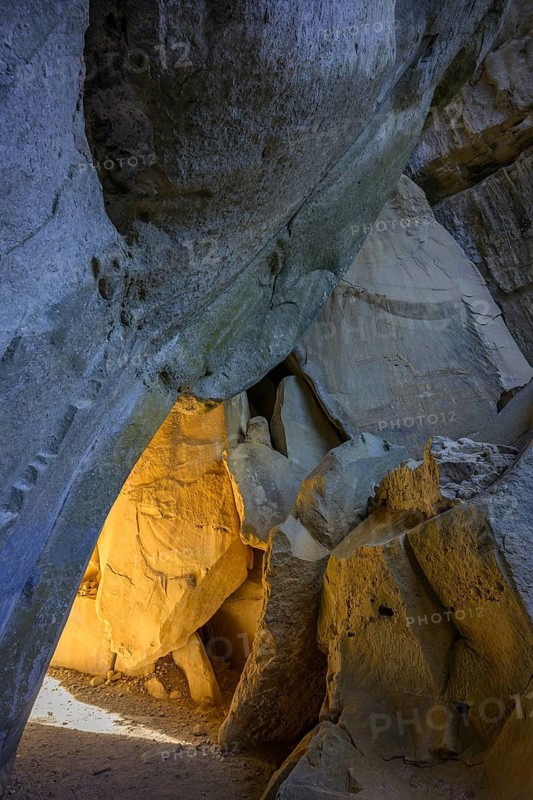 Incidental sun illuminates the passage (Chambre du Roi) through the high rocks, hike through the sandstone labyrinth Grés d'Annot, Alpes-de-Haute-Provence, France