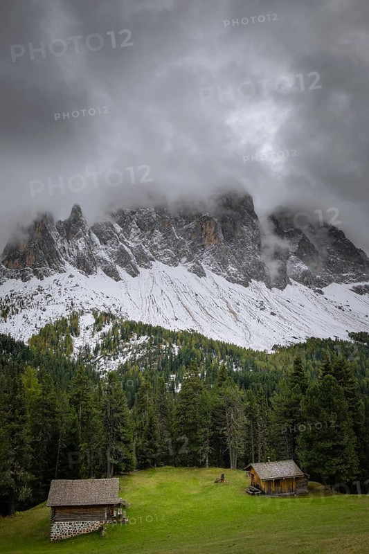 View of a part of the Geisler group in the foreground two mountain huts, Dolomites, snow, Puez-Geisler nature park Park, St. Magdalena, Villnöß, Funes, Villnößtal, South Tyrol, Italy