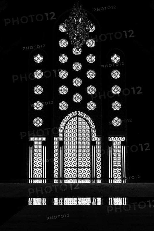 Light incidence in the darkness, interior door and window, arabesque, ornaments in the Hassan II Mosque, backlight with reflection, architecture, interior shot, black and white shot, Casablanca, Morocco