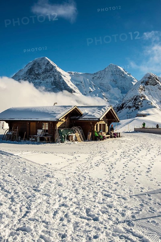 Wooden chalet and ski slope, with views of the Eiger, Mönch and Tschuggen, Grindelwald, Bernese Alps, Canton of Bern, Switzerland