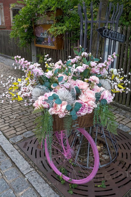 Pink coloured bicycle decorated with artificial flowers, Bavaria, Germany