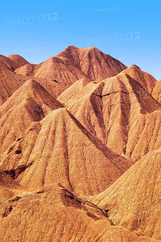Dramatic details of the eroded orange ridges at Devil's Desert located in Salta, Argentina, perfectly capturing the desert's desolate beauty