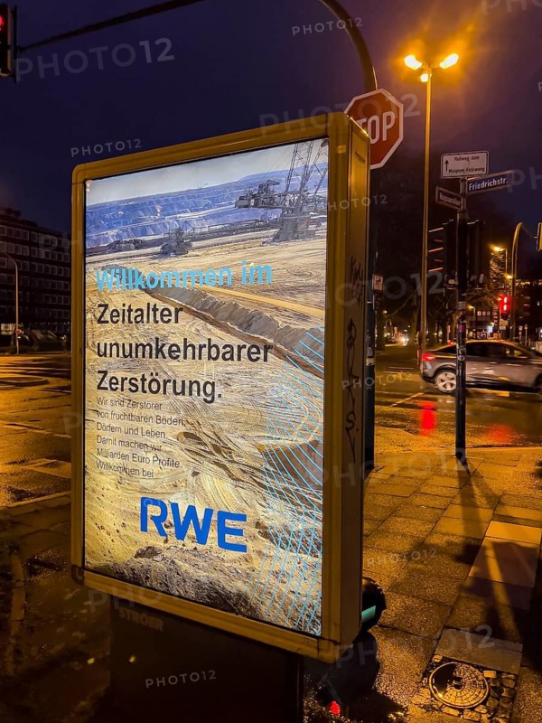 Alleged advertising poster of the energy company RWE, which professes the environmental destruction caused by lignite mining, presumably placed by environmental activists, Essen, North Rhine-Westphalia, Germany