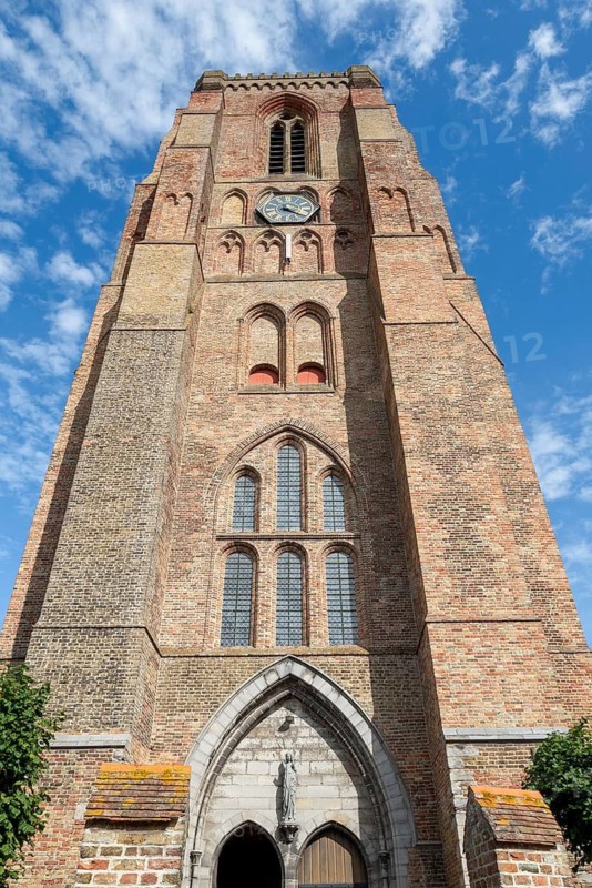 13th century Gothic bell tower of Our Lady's Church, Onze-Lieve-Vrouw-Bezoekingskerk in the village Lissewege near Bruges, West Flanders, Belgium
