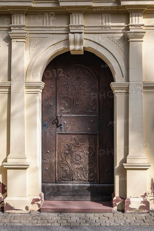 Side portal of the Ruhe-Christi Church with richly decorated wooden door, Rottweil, Rottweil district, Baden-Württemberg, Germany