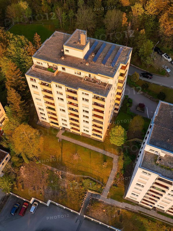 Top view of a high-rise building in a green residential area, illuminated by sunlight, Nagold, Black Forest, Germany