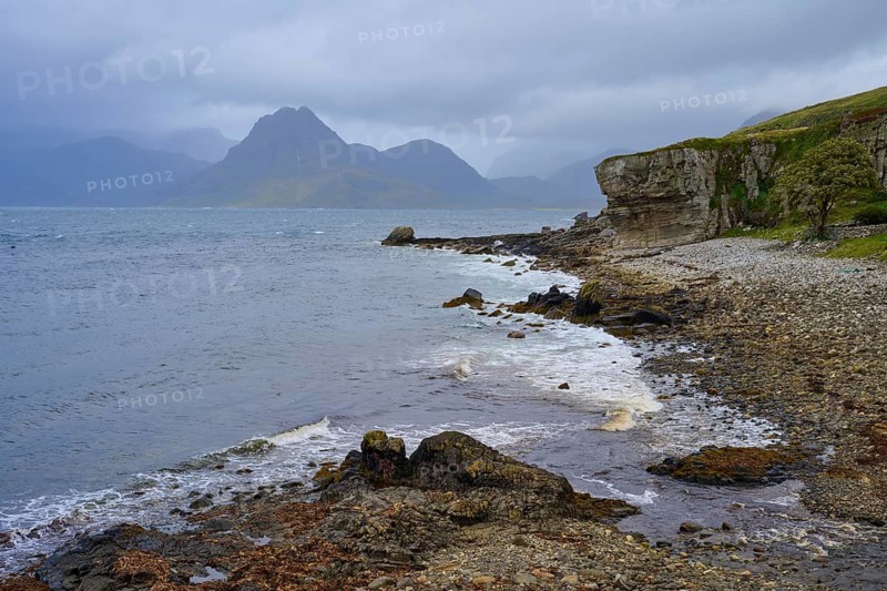 Rocky seaside coast with cloudy sky and mountain backdrop, Elgol Beach, Elgol, Isle of Skye, Scotland, United Kingdom, Great Britain